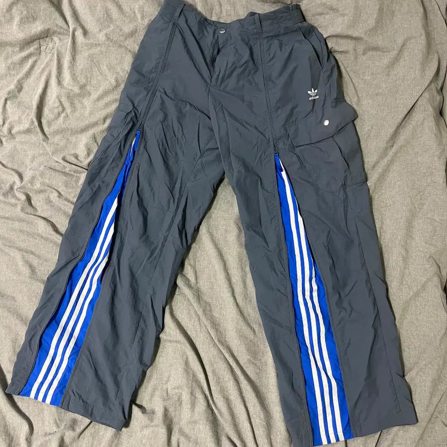 ADIDAS  Originals x KR OP collaboration SS24, featuring a deconstructed clover logo patchwork loose-fitting workwear style with a zipper