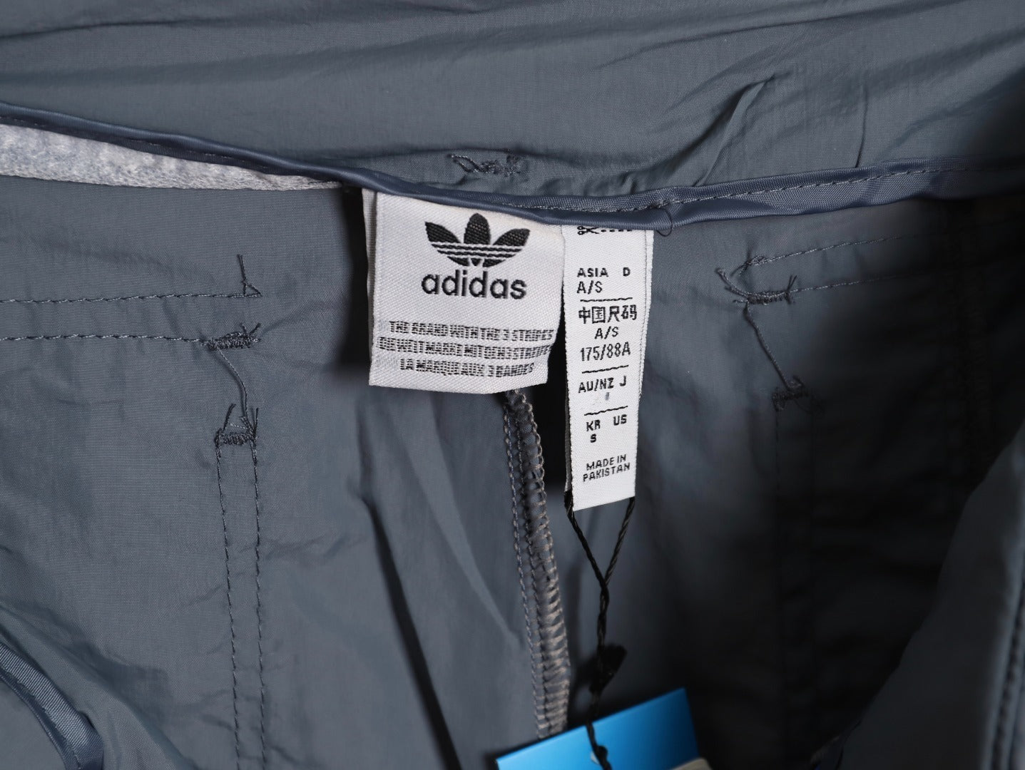ADIDAS  Originals x KR OP collaboration SS24, featuring a deconstructed clover logo patchwork loose-fitting workwear style with a zipper