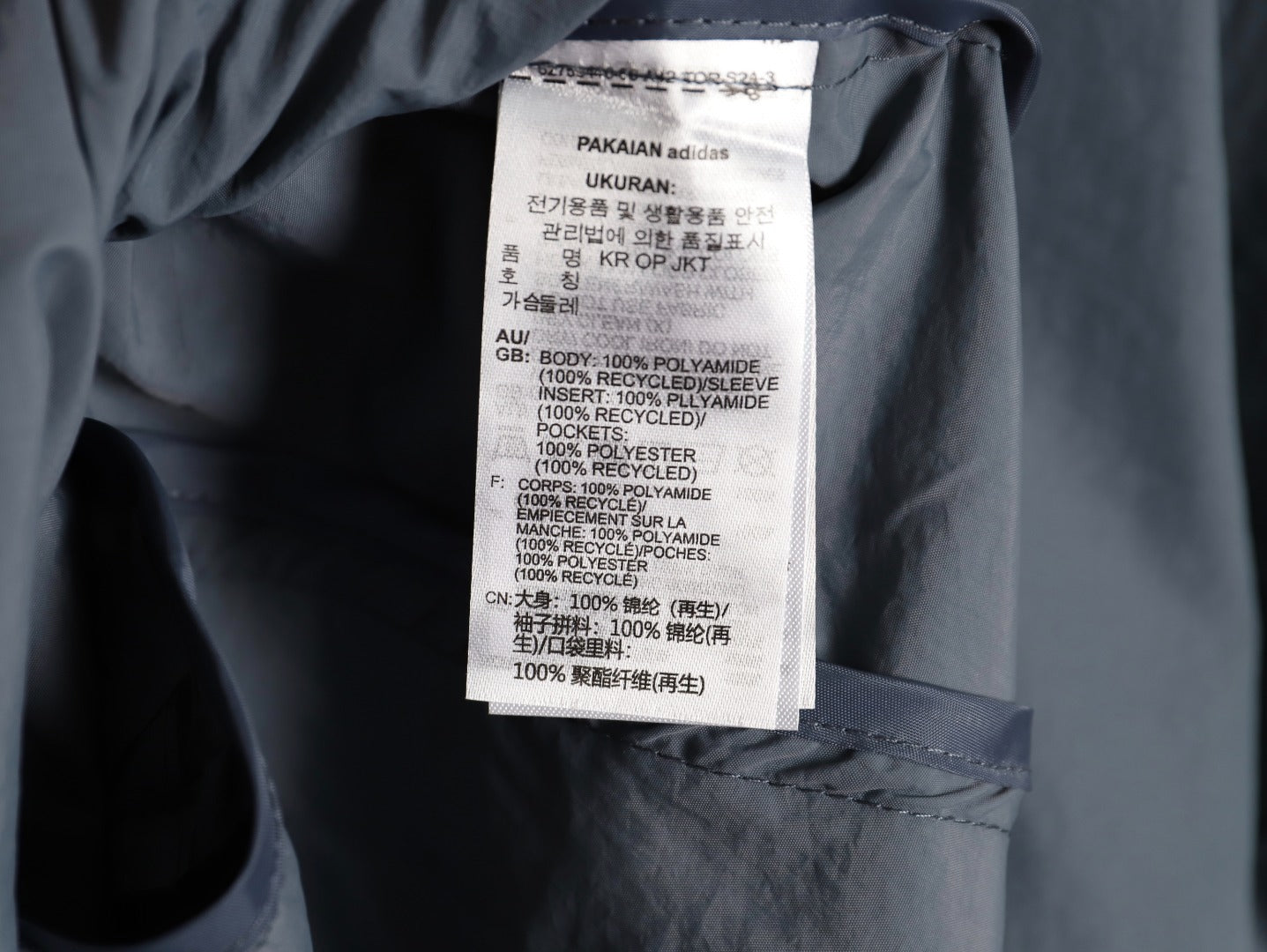 ADIDAS  Originals x KR OP collaboration SS24, featuring a deconstructed clover logo patchwork loose-fitting workwear style with a zipper