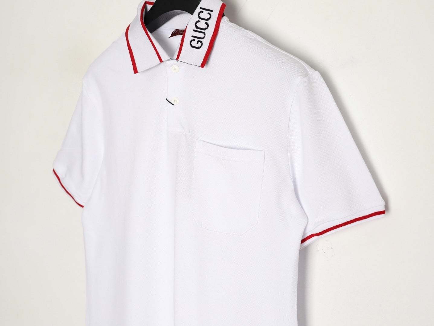 GUCCI short-sleeved polo shirt with lettering and woven ribbon at the neckline.