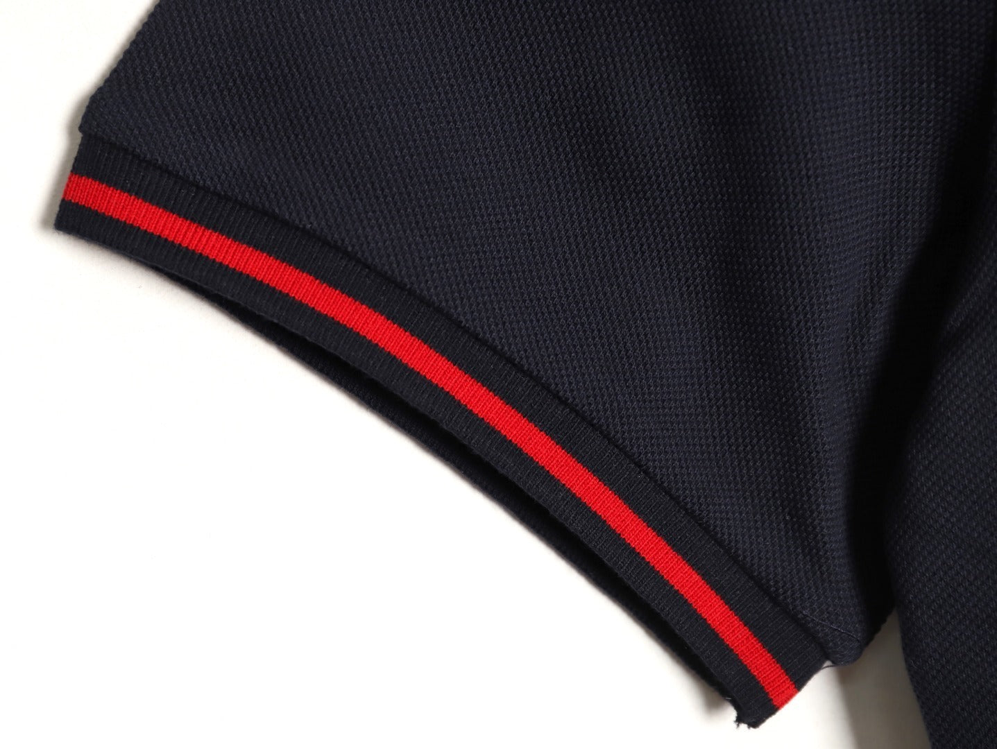 GUCCI short-sleeved polo shirt with lettering and woven ribbon at the neckline.
