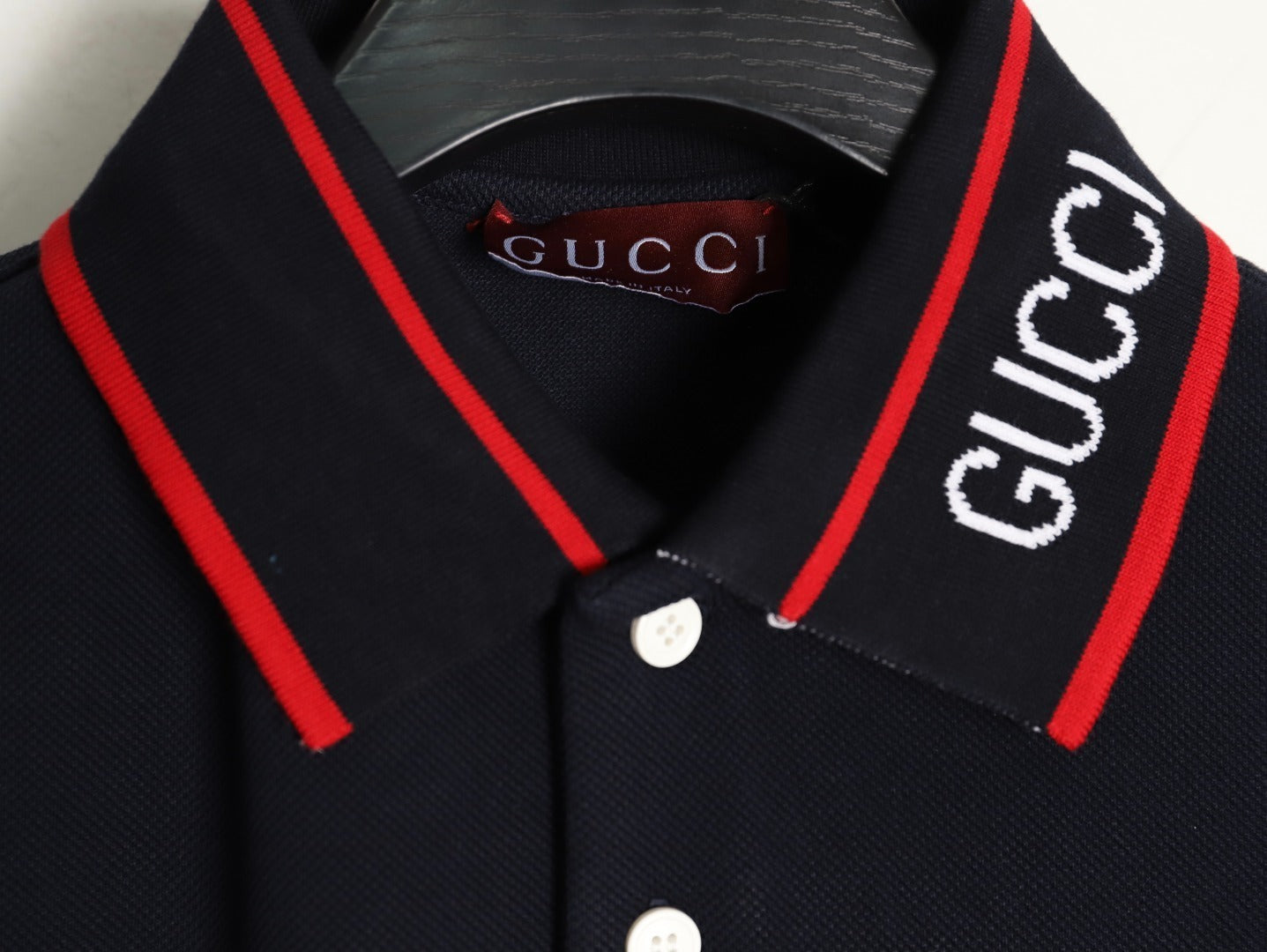 GUCCI short-sleeved polo shirt with lettering and woven ribbon at the neckline.