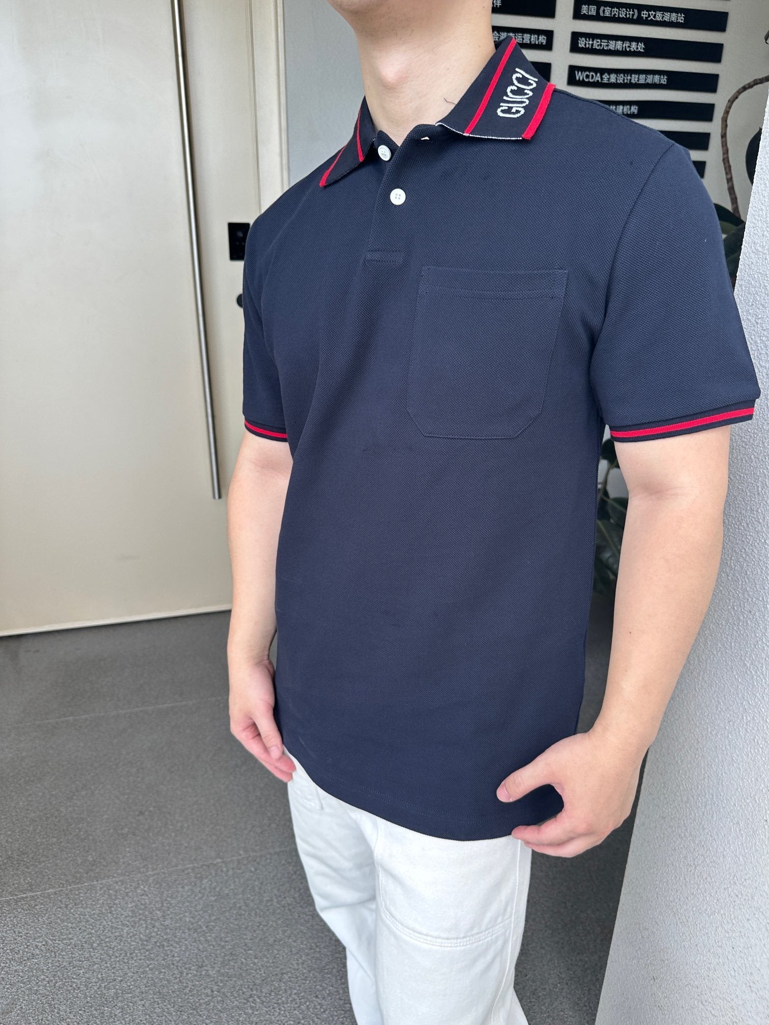 GUCCI short-sleeved polo shirt with lettering and woven ribbon at the neckline.