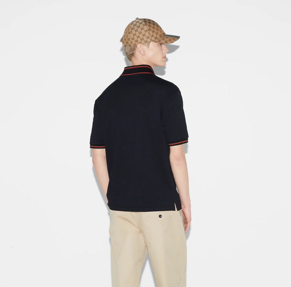 GUCCI short-sleeved polo shirt with lettering and woven ribbon at the neckline.
